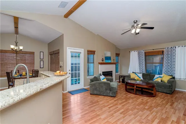 a living room with furniture fireplace and a table