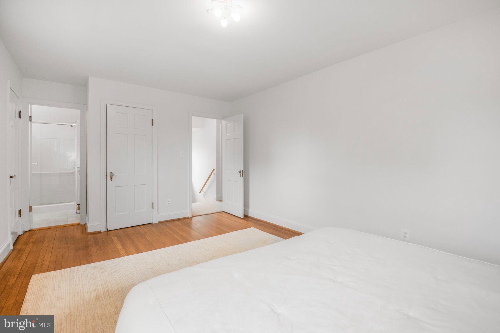 6011 Broad Branch Road Northwest Washington, DC 20015 - Photo 12 of 27 a bedroom with a bed and a white wall