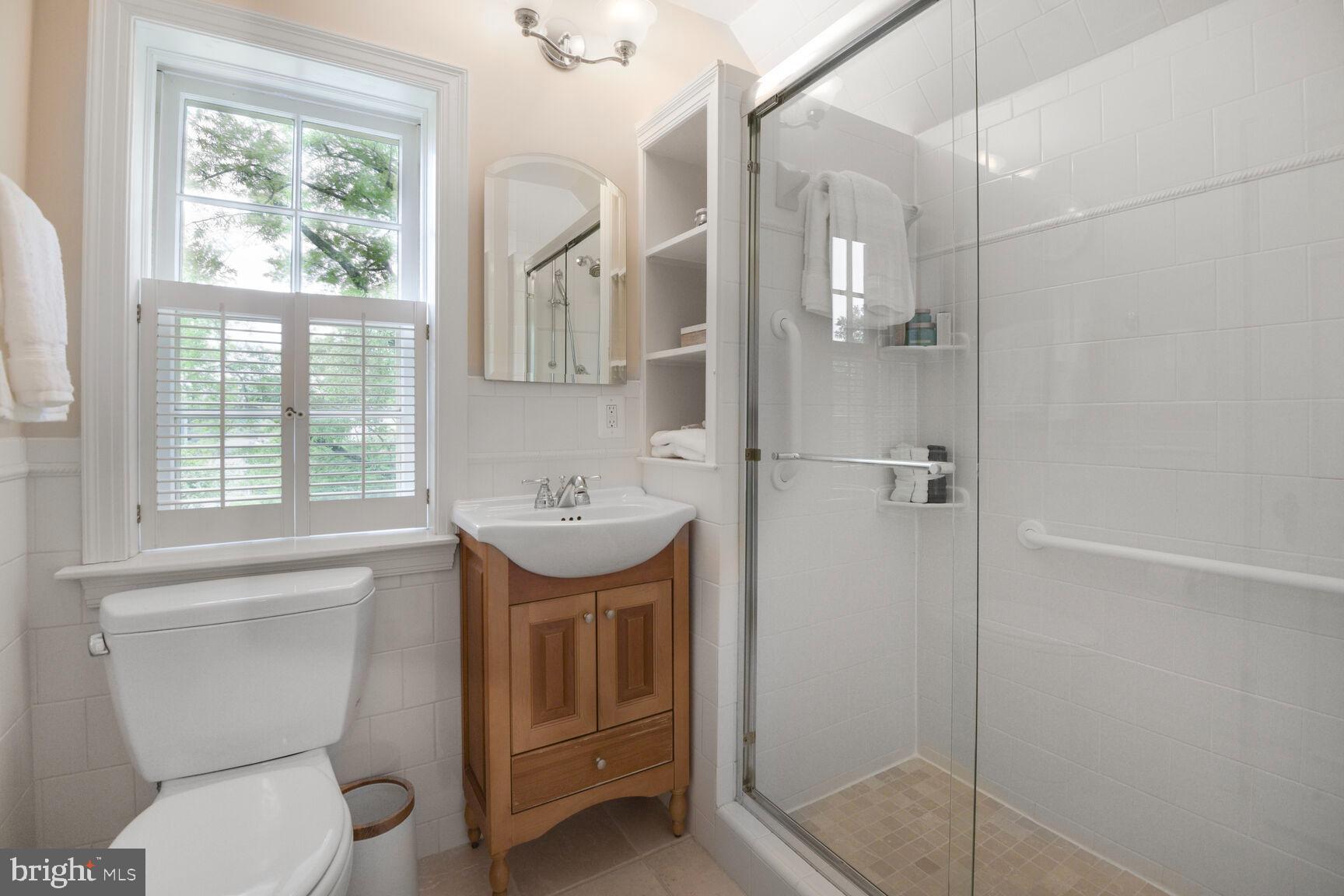6011 Broad Branch Road Northwest Washington, DC 20015 - Photo 13 of 27 a bathroom with a sink toilet and shower