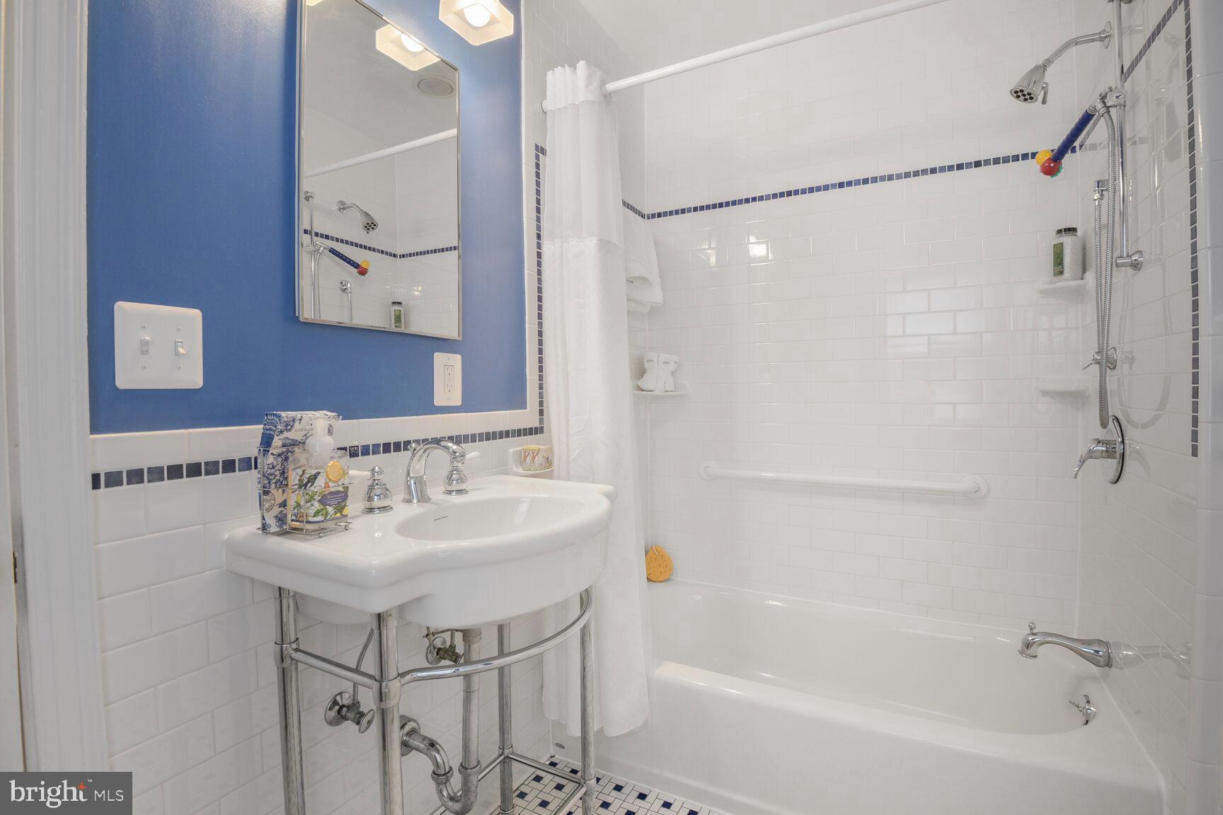 6011 Broad Branch Road Northwest Washington, DC 20015 - Photo 14 of 27 a bathroom with a sink mirror and a bathtub