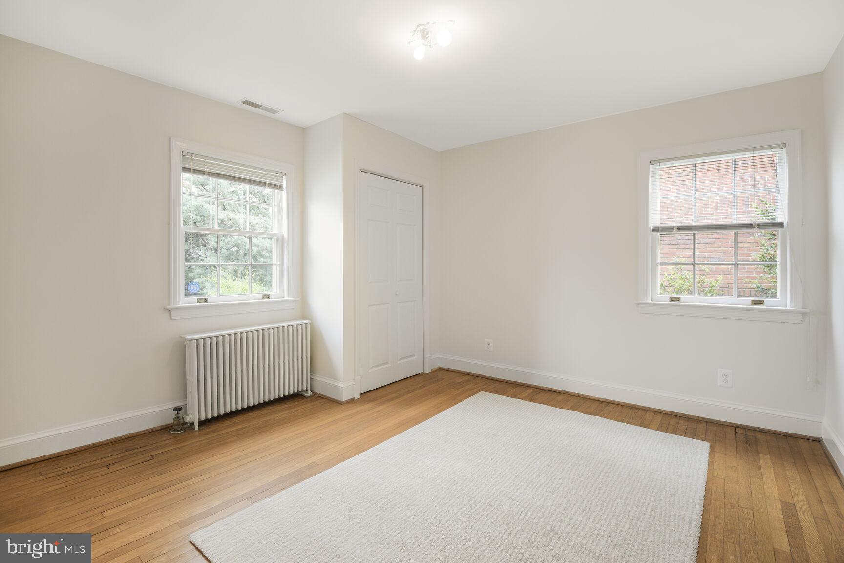 6011 Broad Branch Road Northwest Washington, DC 20015 - Photo 15 of 27 an empty room with wooden floor and windows