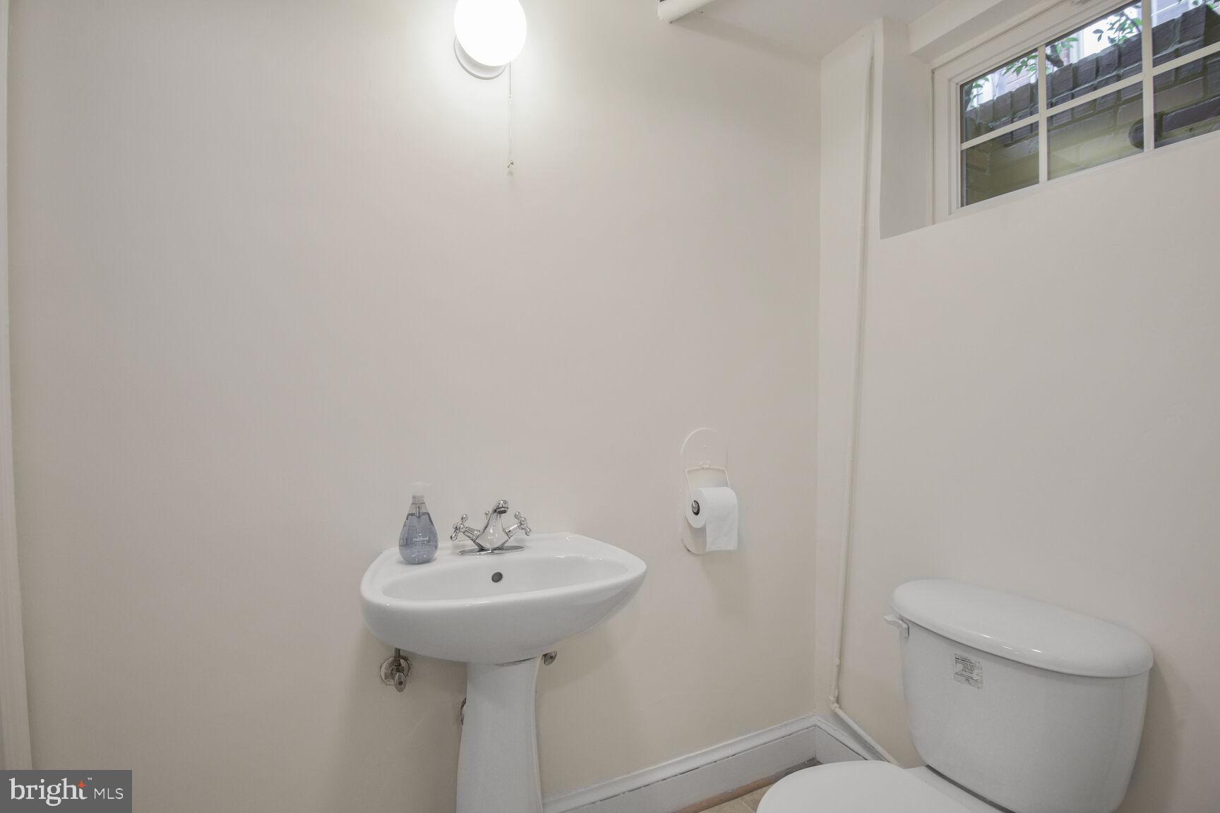 6011 Broad Branch Road Northwest Washington, DC 20015 - Photo 22 of 27 a bathroom with a sink toilet and a mirror