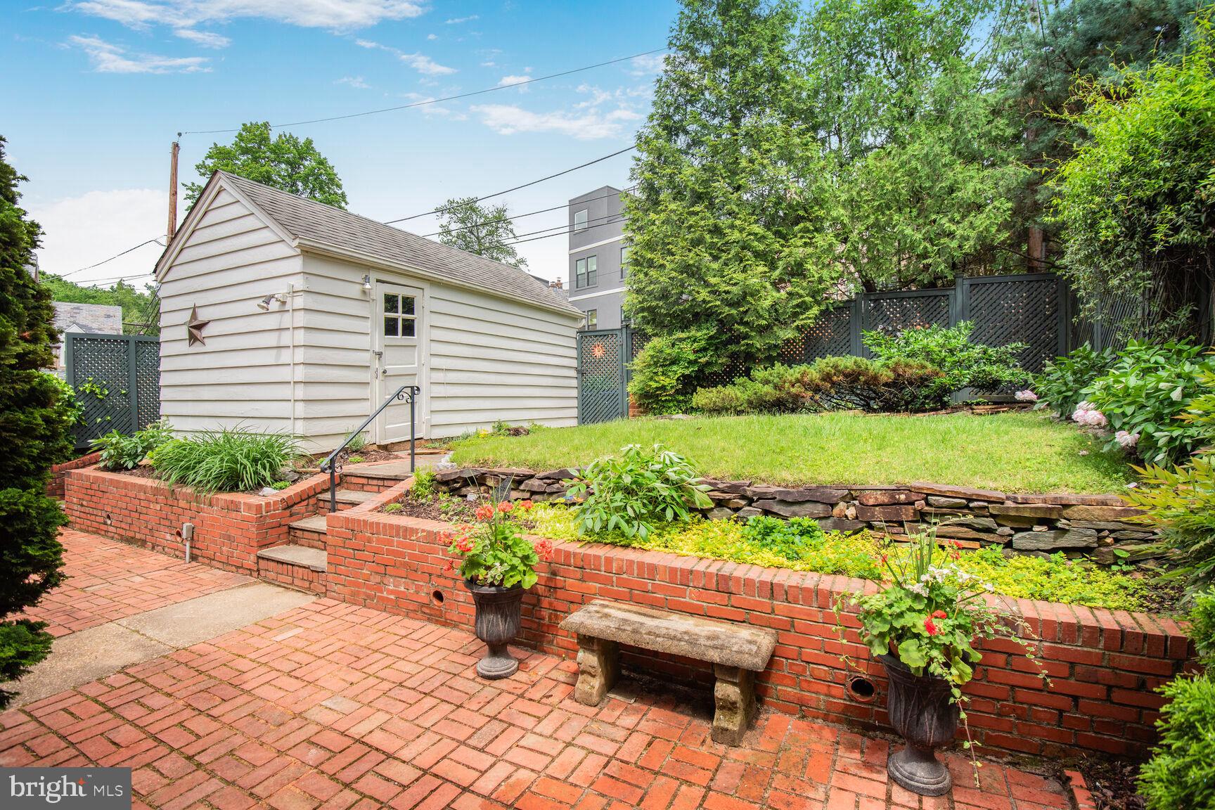6011 Broad Branch Road Northwest Washington, DC 20015 - Photo 25 of 27 a view of a house with a yard and a garden