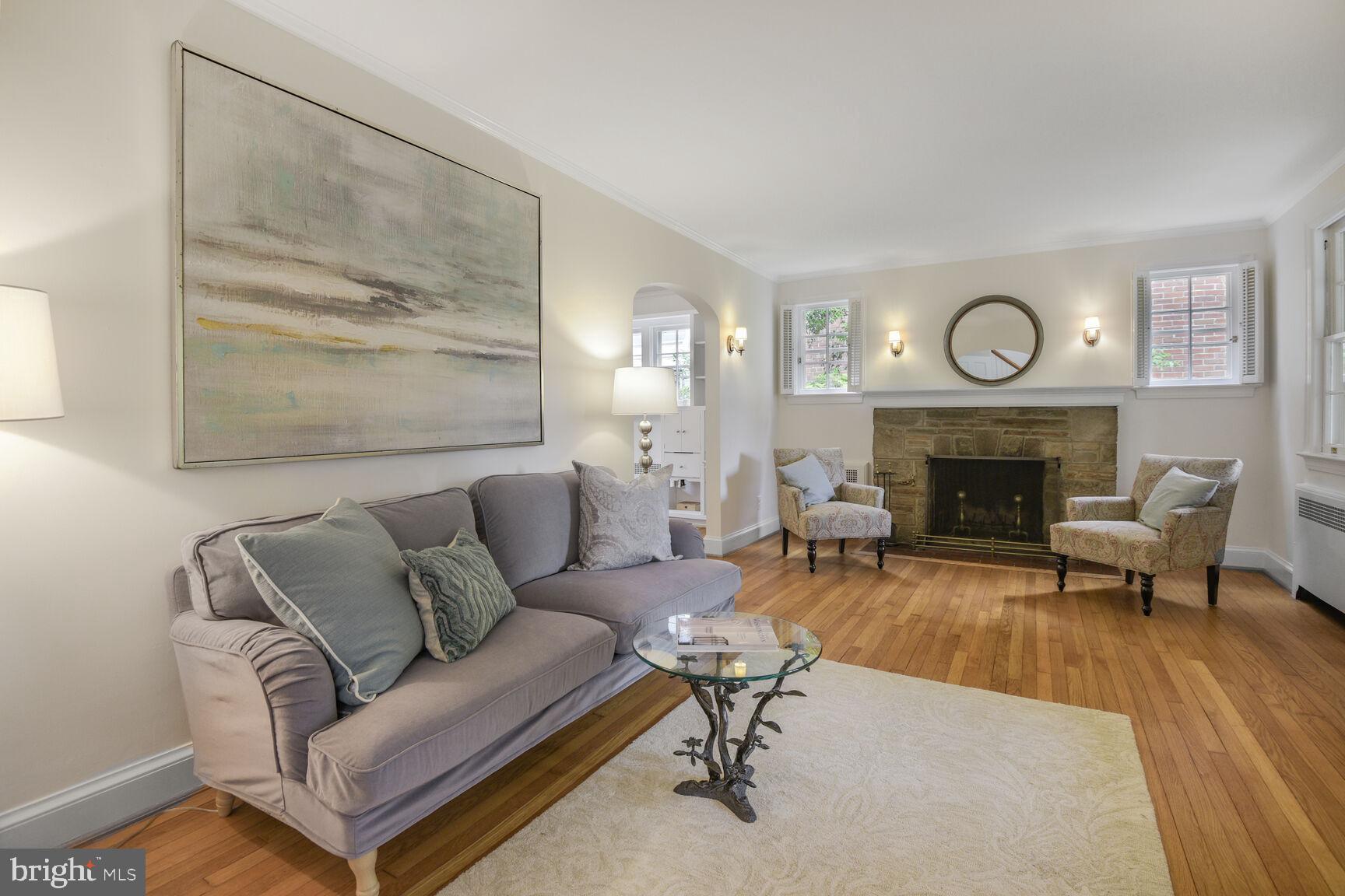 6011 Broad Branch Road Northwest Washington, DC 20015 - Photo 4 of 27 a living room with furniture a clock and a fireplace