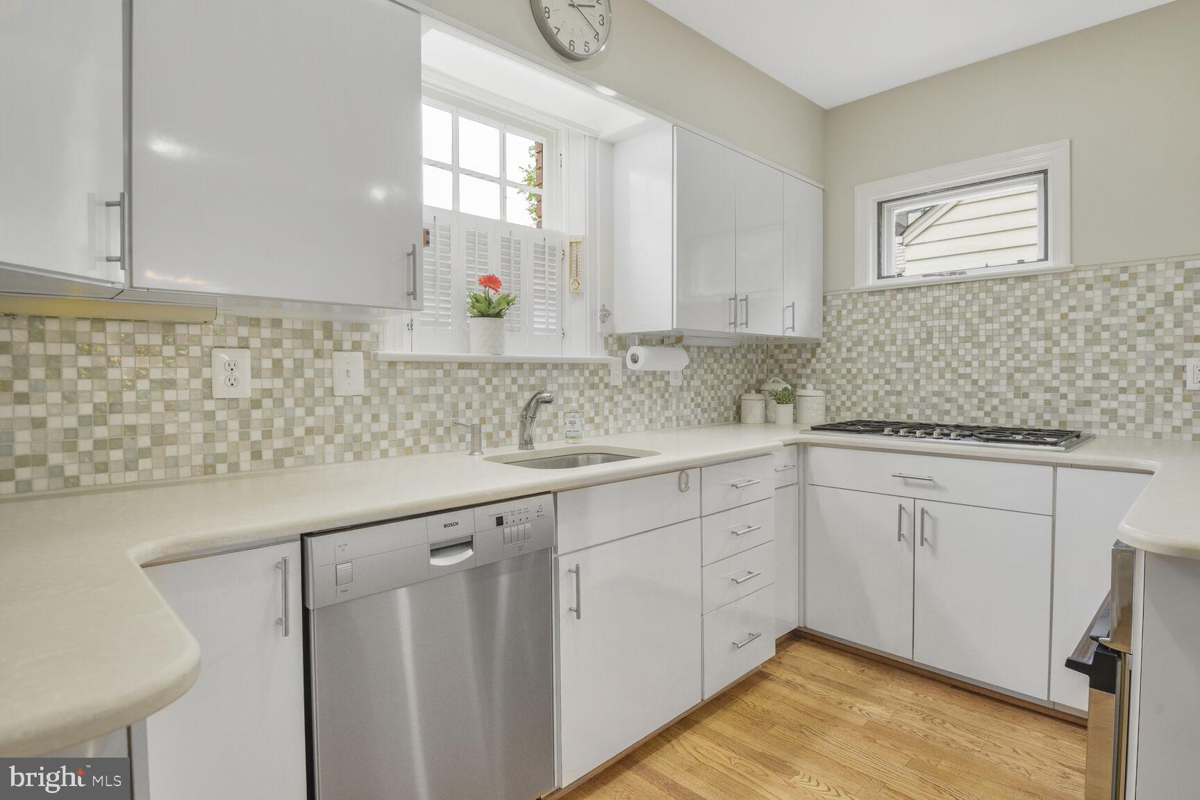 6011 Broad Branch Road Northwest Washington, DC 20015 - Photo 7 of 27 a kitchen with sink cabinets and window