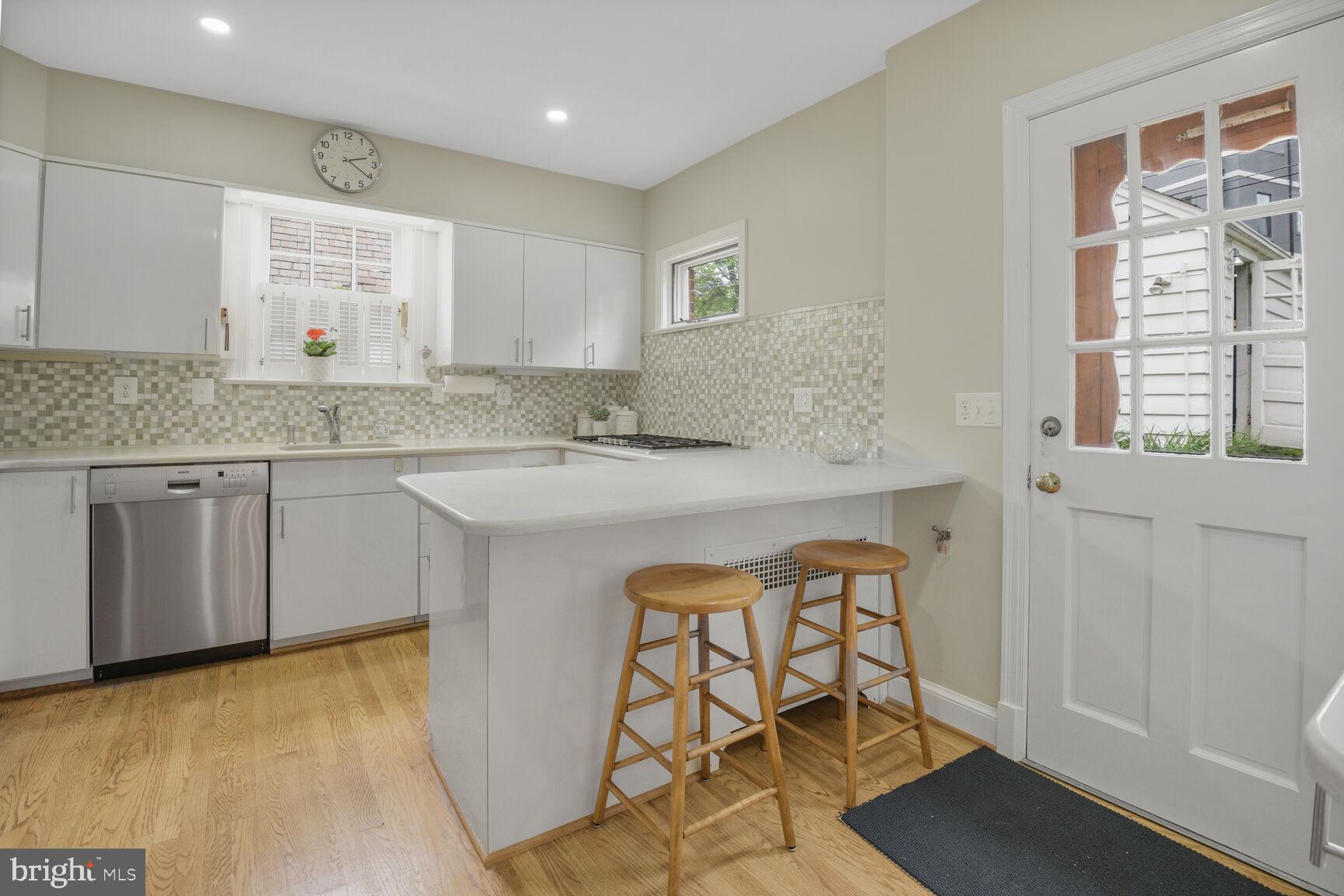 6011 Broad Branch Road Northwest Washington, DC 20015 - Photo 8 of 27 a kitchen with stainless steel appliances granite countertop a stove a sink and a refrigerator