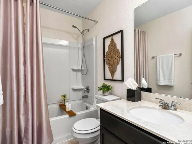 a bathroom with a granite countertop sink toilet a mirror a vanity and shower