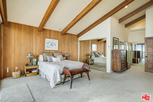 a bedroom with a bed and a chair
