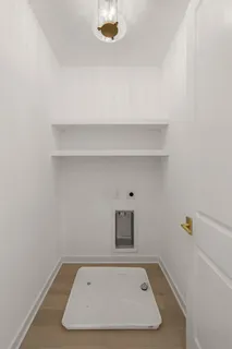 a bathroom with a toilet sink vanity tub and mirror