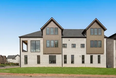 an aerial view of a house with a big yard