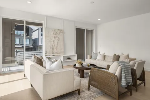 a living room with furniture and large windows