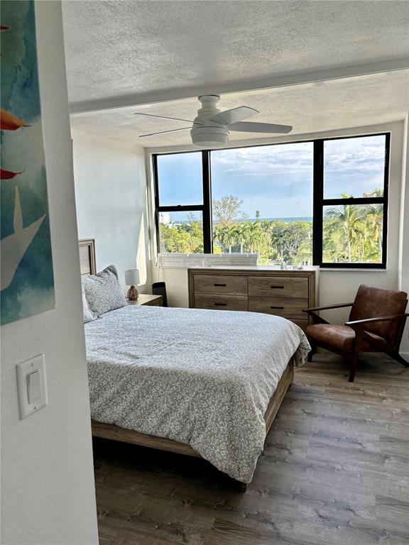 5855 Midnight Pass Road, Unit 621 Sarasota, FL 34242 - Photo 12 of 26 a bedroom with a bed and a large window