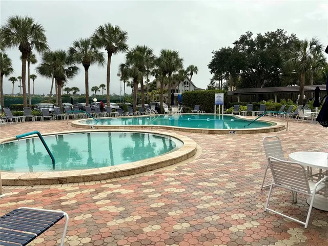 a view of a swimming pool with outdoor seating