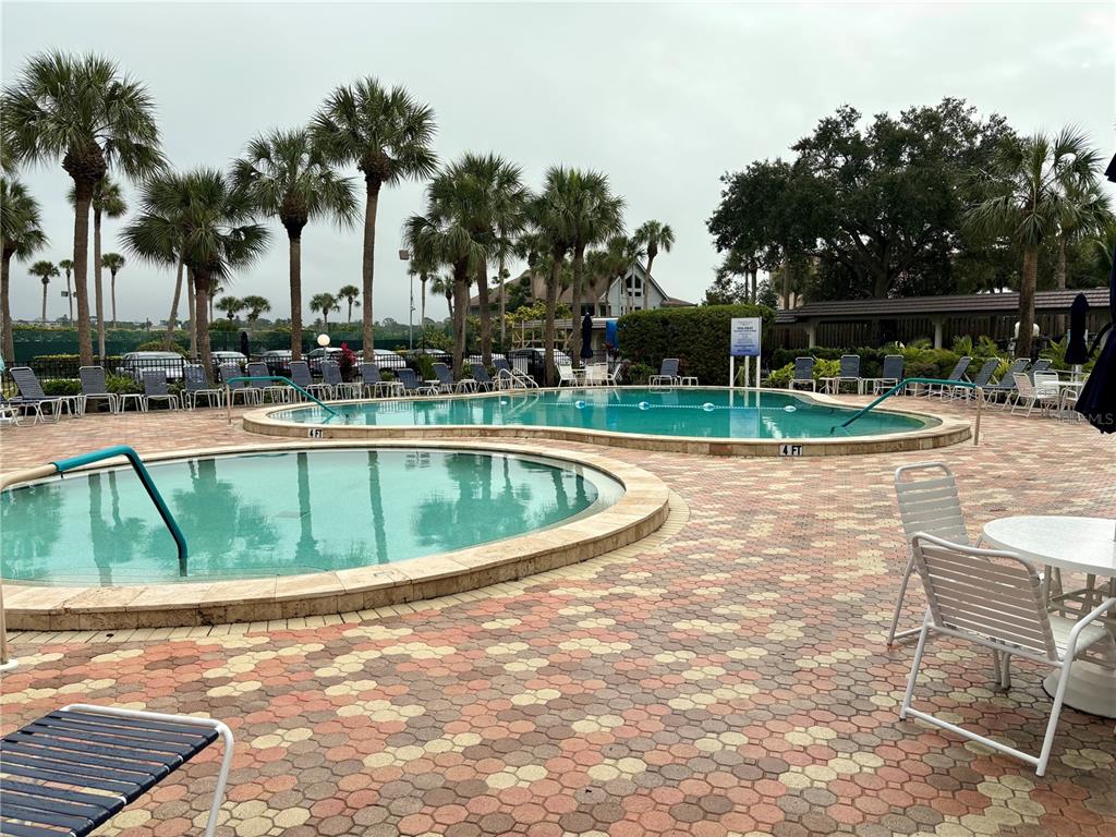 5855 Midnight Pass Road, Unit 621 Sarasota, FL 34242 - Photo 15 of 26 a view of a swimming pool with a lounge chair