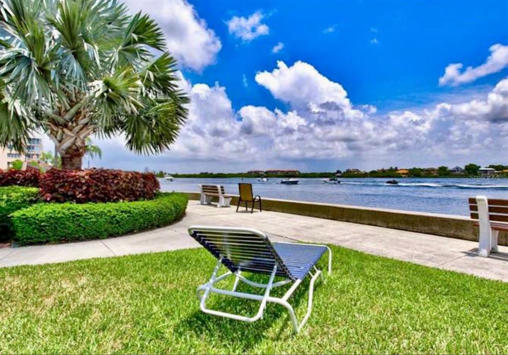 5855 Midnight Pass Road, Unit 621 Sarasota, FL 34242 - Photo 17 of 26 a view of a swimming pool and lounge chairs
