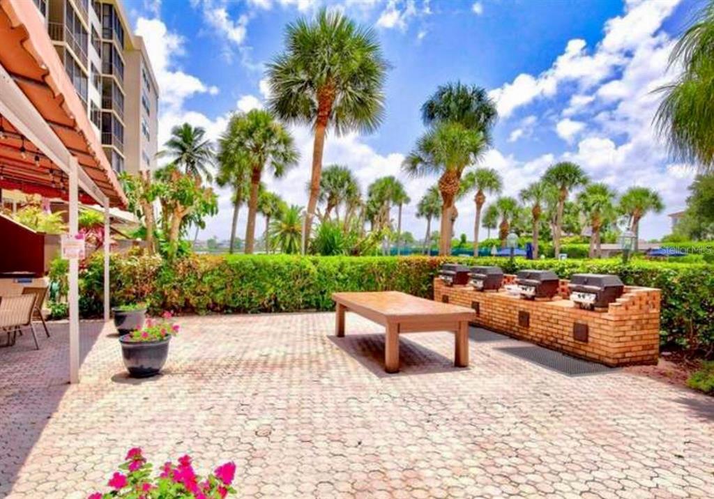 5855 Midnight Pass Road, Unit 621 Sarasota, FL 34242 - Photo 19 of 26 a view of patio with couches and a fire pit