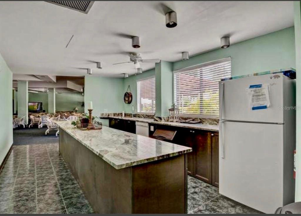 5855 Midnight Pass Road, Unit 621 Sarasota, FL 34242 - Photo 21 of 26 a kitchen with a sink a counter top space and stainless steel appliances