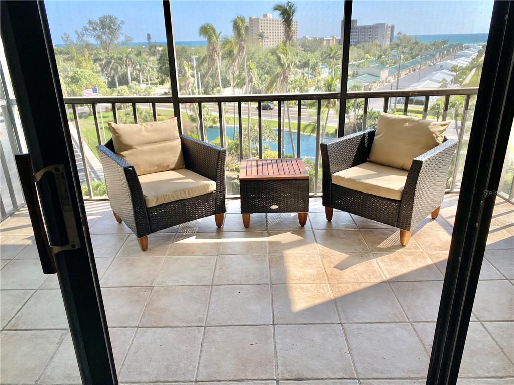 5855 Midnight Pass Road, Unit 621 Sarasota, FL 34242 - Photo 3 of 26 a living room with furniture and a floor to ceiling window