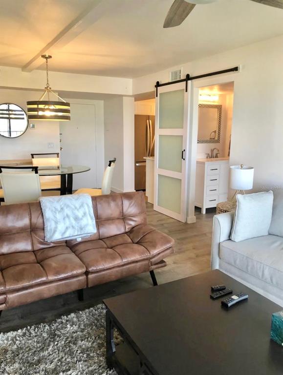 5855 Midnight Pass Road, Unit 621 Sarasota, FL 34242 - Photo 5 of 26 a living room with furniture and a chandelier