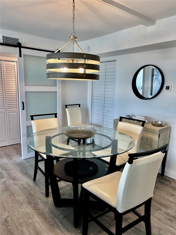 5855 Midnight Pass Road, Unit 621 Sarasota, FL 34242 - Photo 8 of 26 a dining room with furniture and window