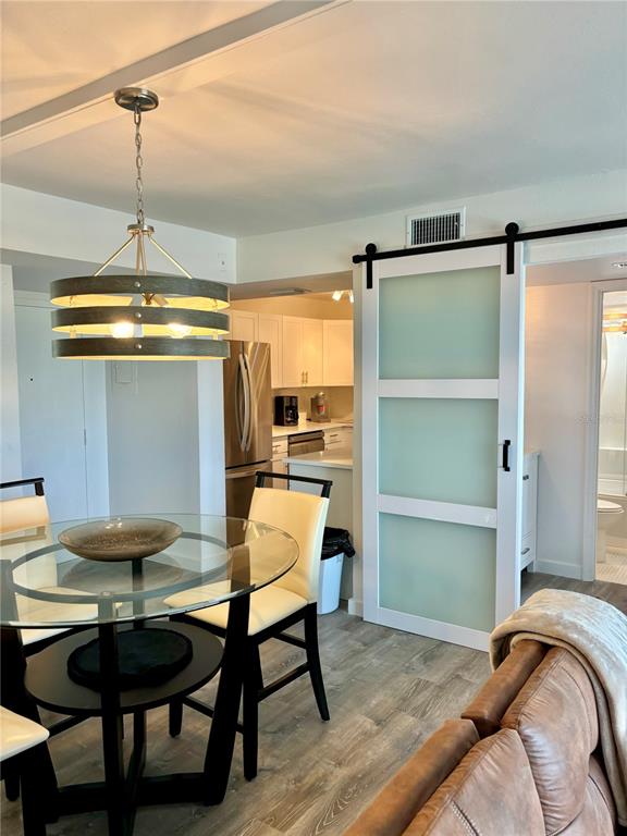 5855 Midnight Pass Road, Unit 621 Sarasota, FL 34242 - Photo 9 of 26 a bedroom with a bed and a table