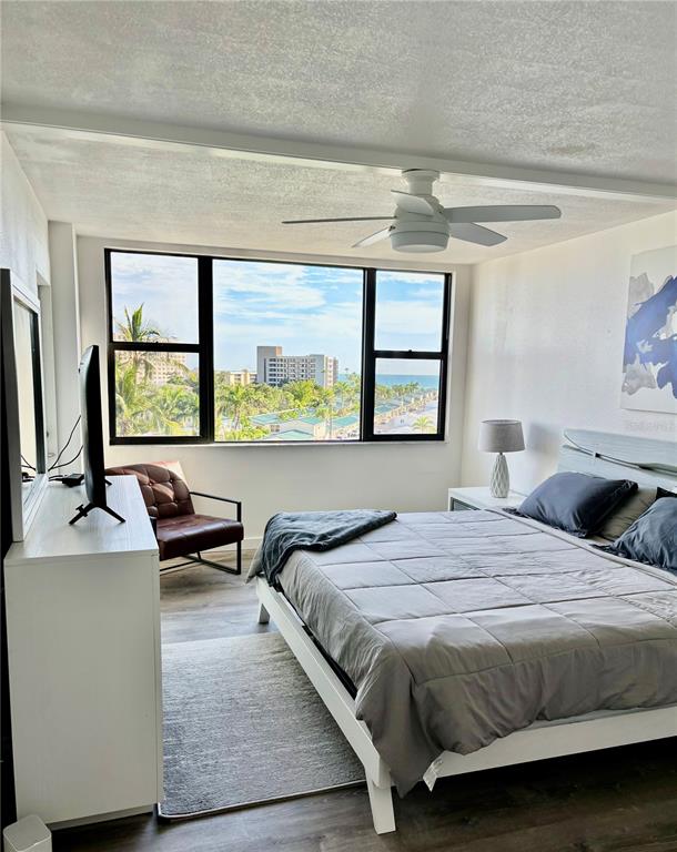 5855 Midnight Pass Road, Unit 621 Sarasota, FL 34242 - Photo 10 of 26 a bedroom with a bed and a large window