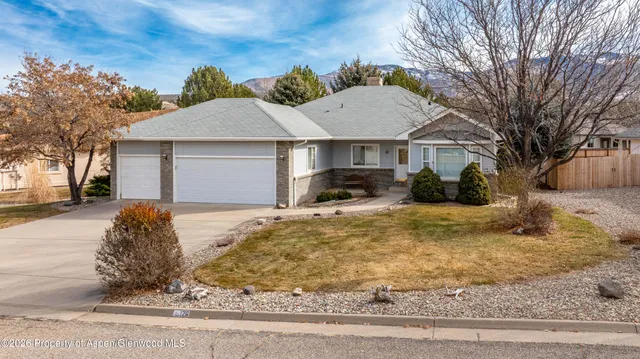 a view of a white house with a yard covered in snow