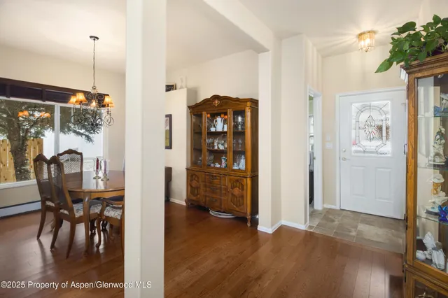 a view of a dining room with furniture and chandelier