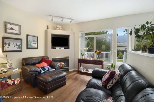 a kitchen with white cabinets and wooden floors
