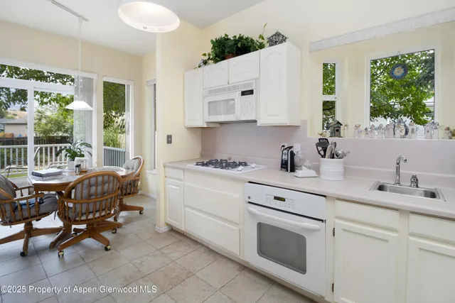 a kitchen with a sink stove top oven and cabinets