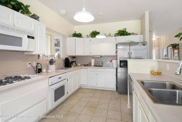 a bedroom with a bed and large window