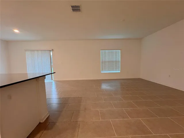 an empty room with a empty space and a window