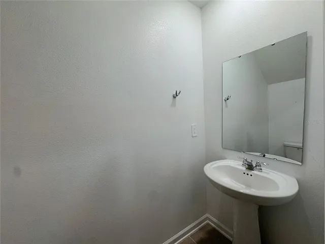 a bathroom with a sink and mirror