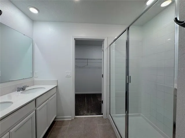 a bathroom with a double vanity sink and a mirror