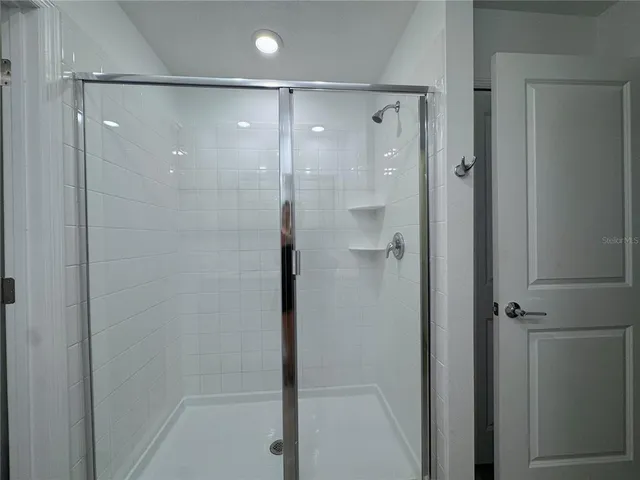 a bathroom with a glass shower door
