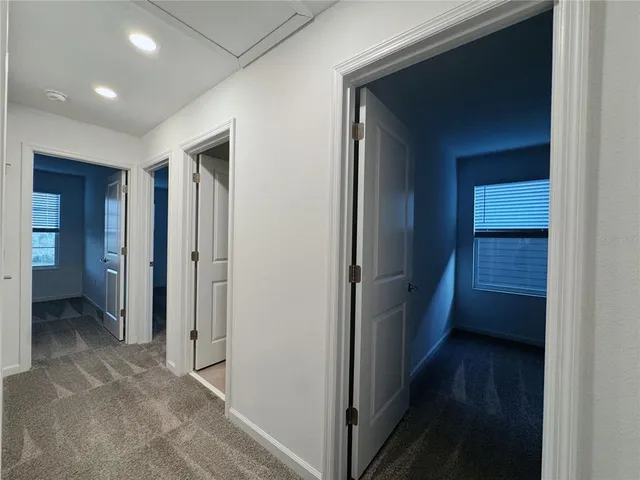 a view of hallway with wooden floor
