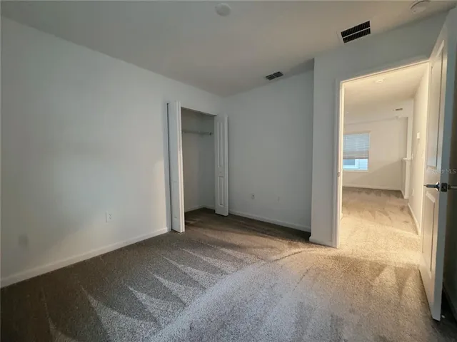 a view of an empty room and a window