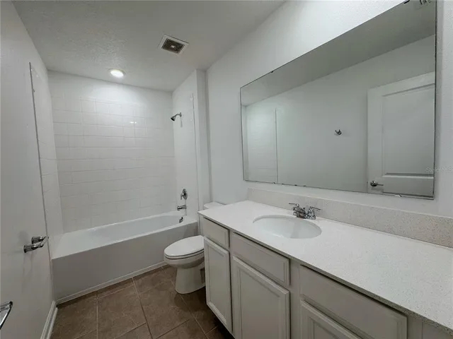 a bathroom with a sink toilet vanity and bathtub