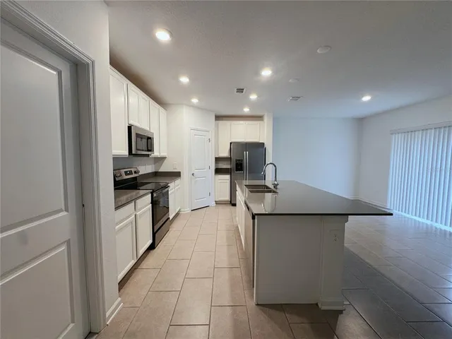 a kitchen with stainless steel appliances a refrigerator stove microwave and cabinets