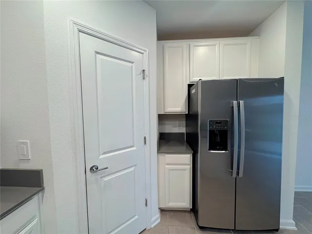 a metallic refrigerator freezer sitting in a kitchen