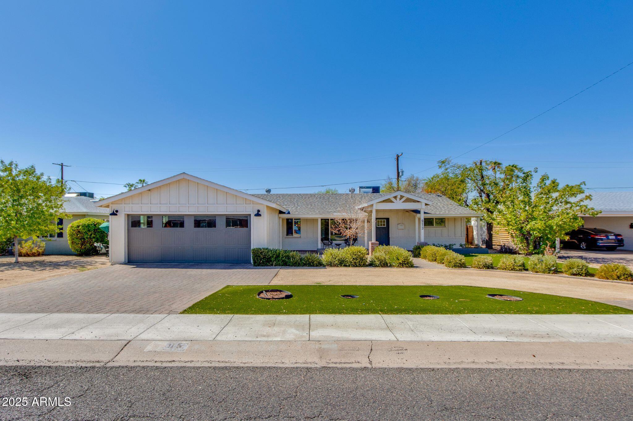 913 West Missouri Avenue Phoenix, AZ 85013 - Photo 1 of 38 a front view of a house with a yard and garage