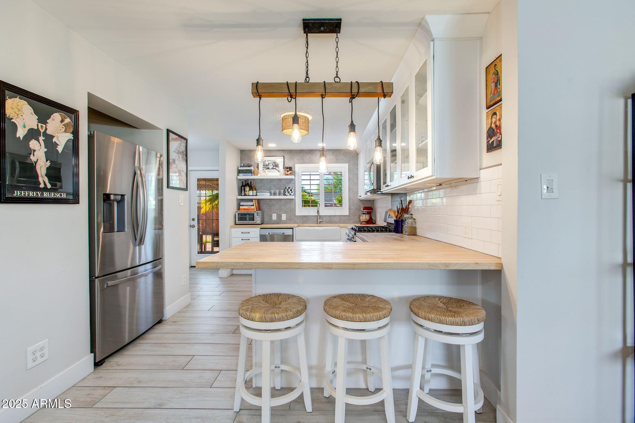 913 West Missouri Avenue Phoenix, AZ 85013 - Photo 13 of 38 a kitchen with a dining table and chairs