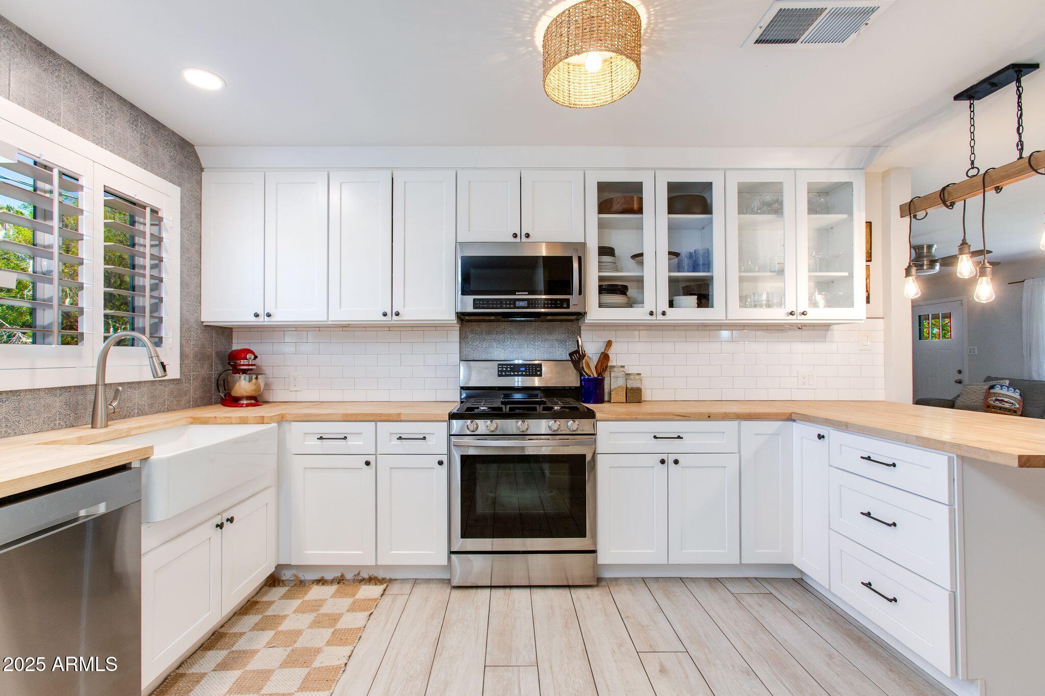 913 West Missouri Avenue Phoenix, AZ 85013 - Photo 17 of 38 a kitchen with cabinets stainless steel appliances a sink and a window