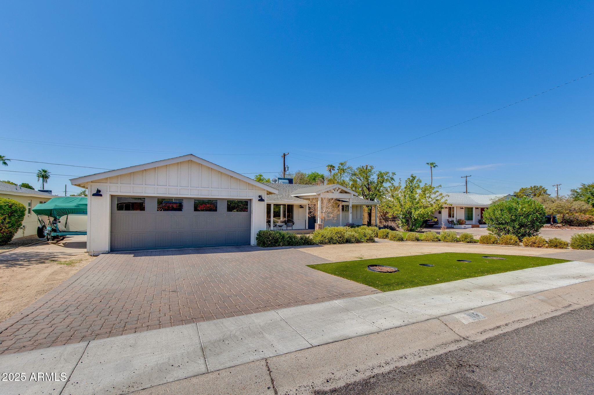 913 West Missouri Avenue Phoenix, AZ 85013 - Photo 2 of 38 a front view of a house with a yard and garage