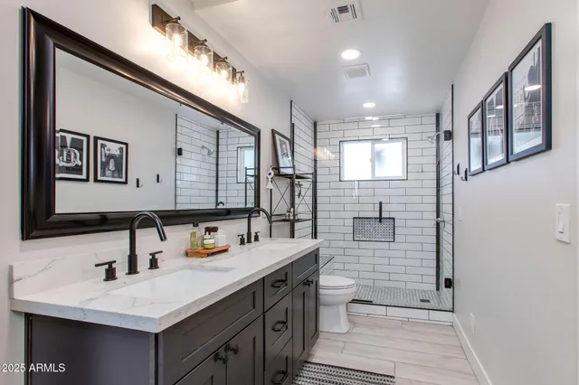 a bathroom with a sink double vanity and a shower