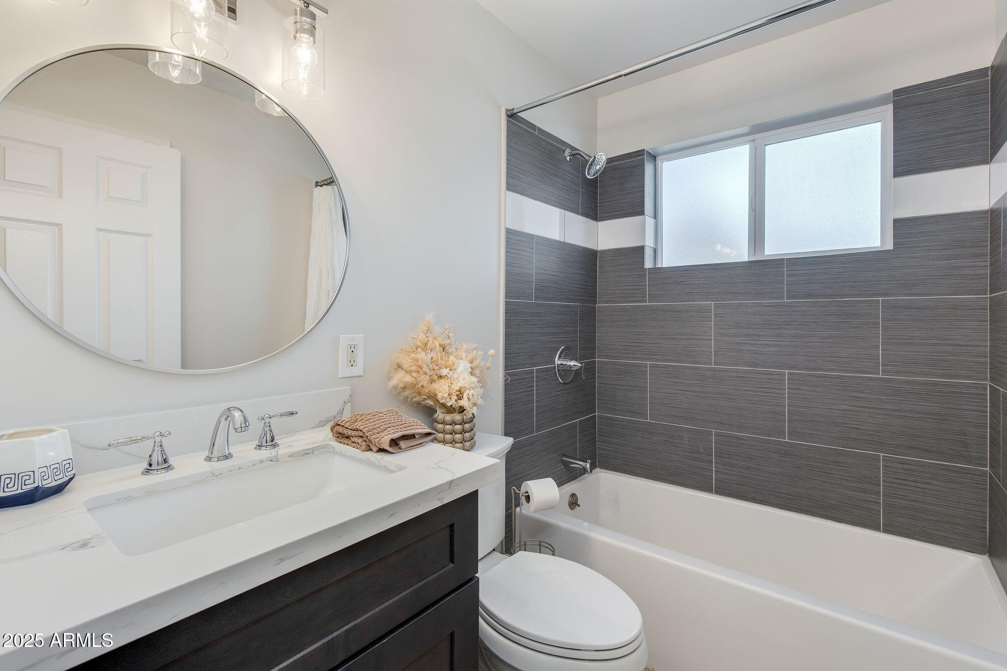 913 West Missouri Avenue Phoenix, AZ 85013 - Photo 29 of 38 a bathroom with a sink a toilet and bathtub