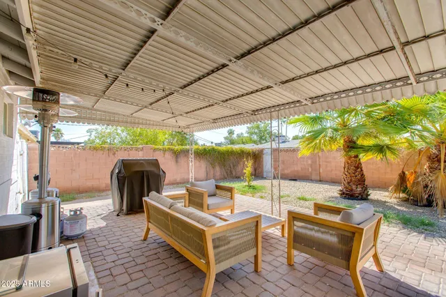 a view of a patio with table and chairs potted plants with wooden floor and fence