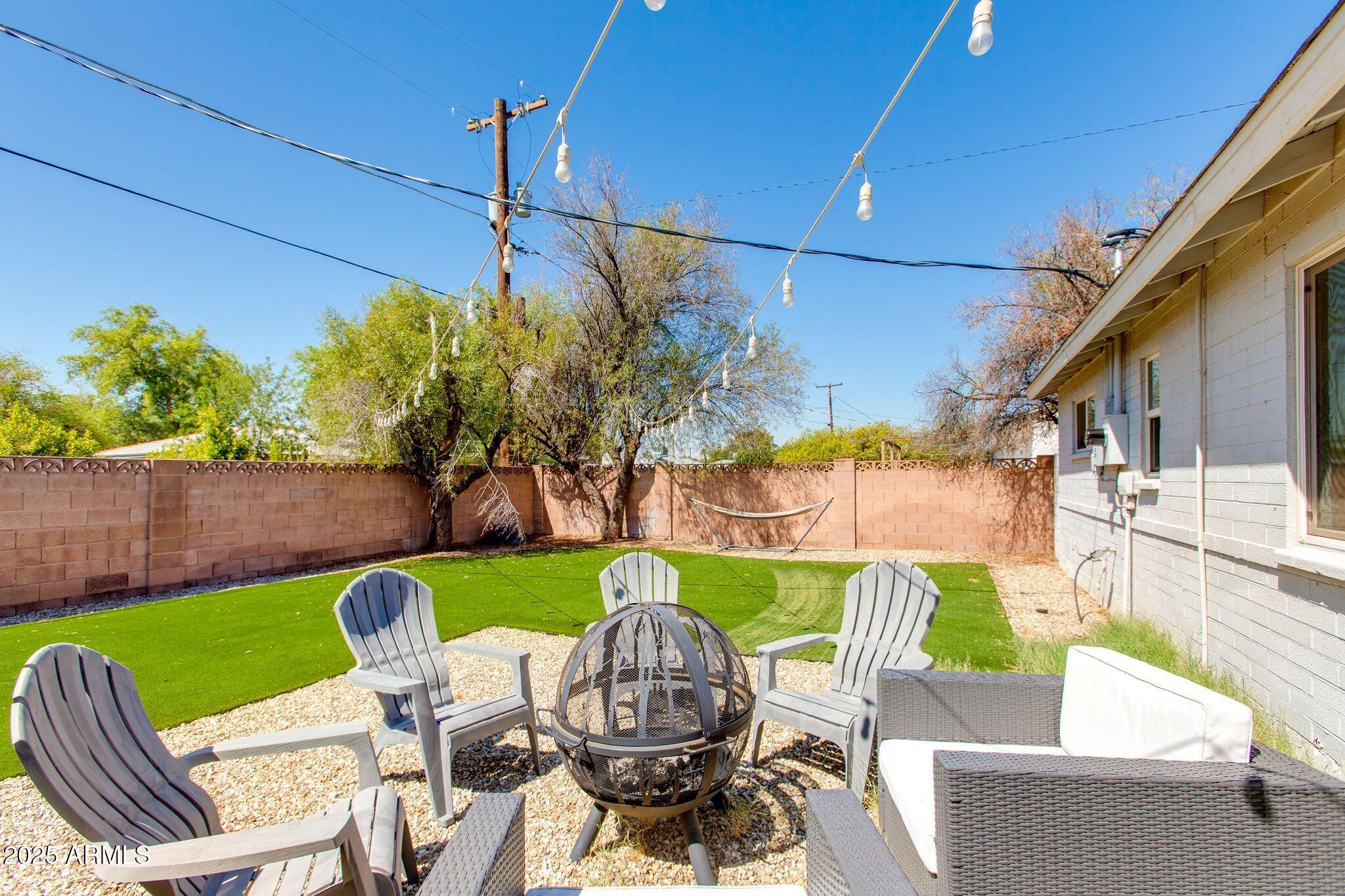 913 West Missouri Avenue Phoenix, AZ 85013 - Photo 33 of 38 a view of a patio with table and chairs potted plants with wooden fence