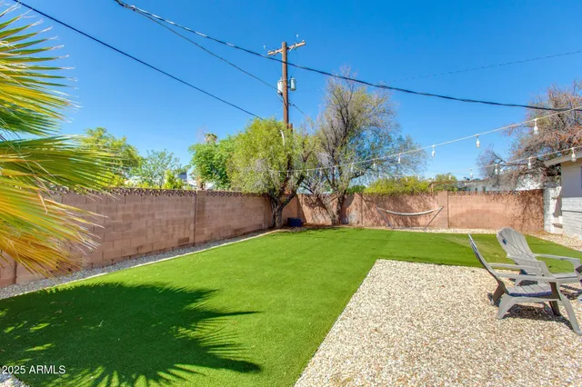 a view of a backyard with plants and a patio