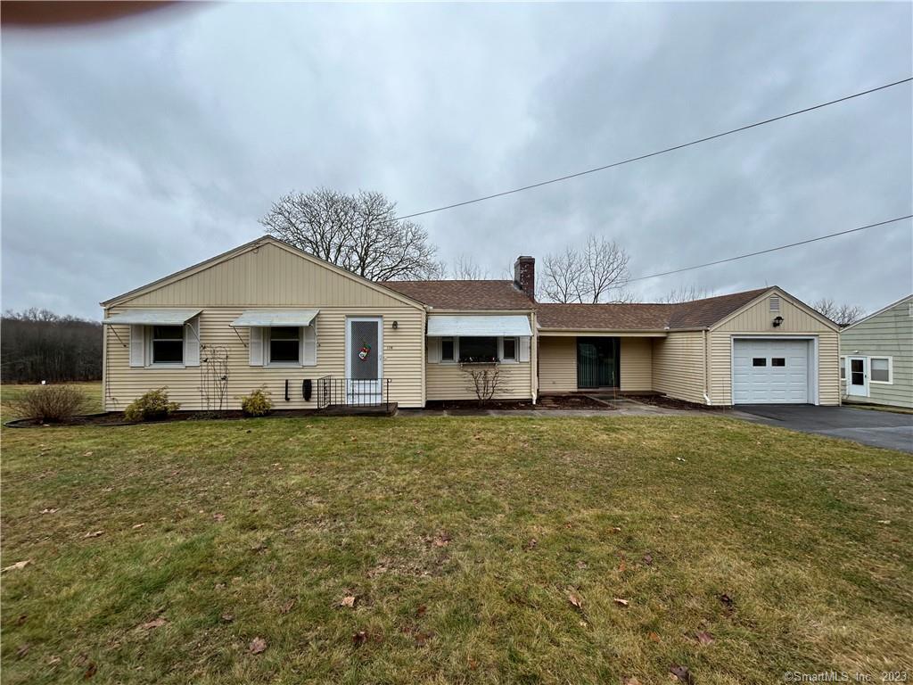 a front view of a house with a garden and yard